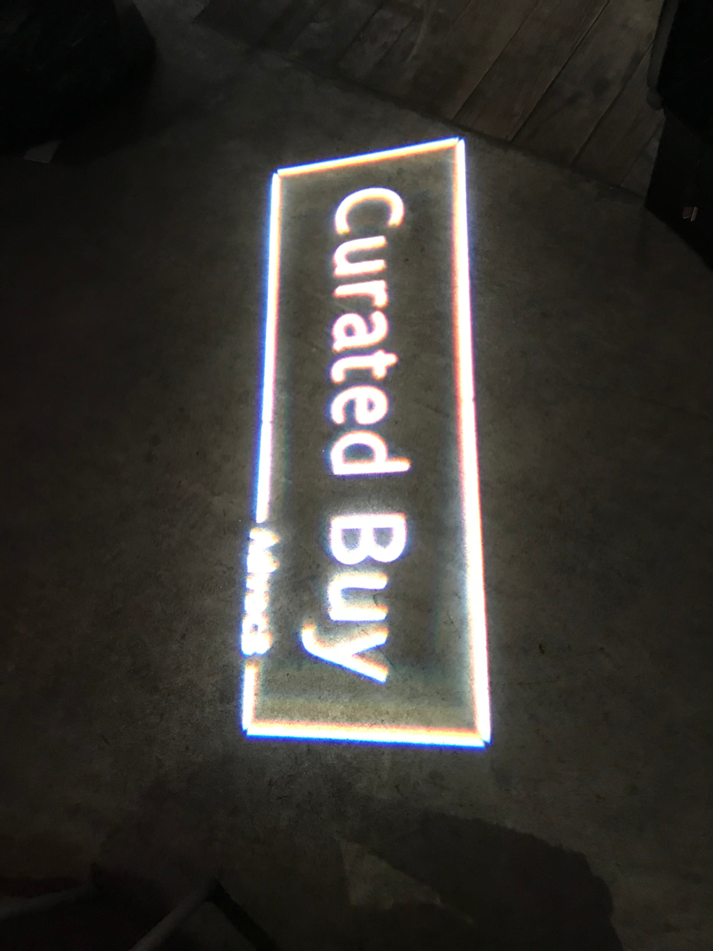 Curated Buy logo projected onto the floor of the pop-up venue